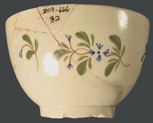Hand-painted pearlware handleless tea cup (blue,
green and brown)
